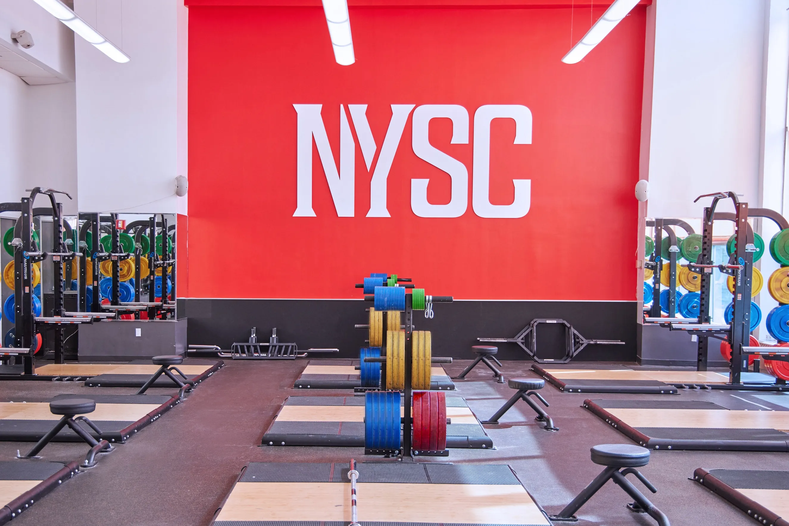 Gym floor with a full red wall carrying the NYSC wordmark