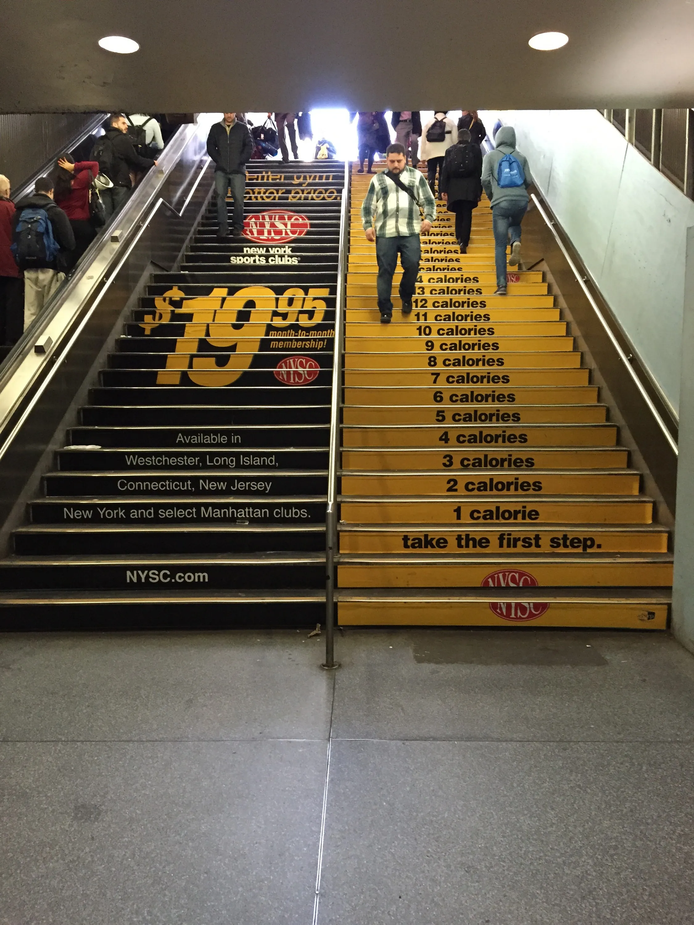 Subway staircase wrapped with NYSC calorie-count graphics, one calorie per step
